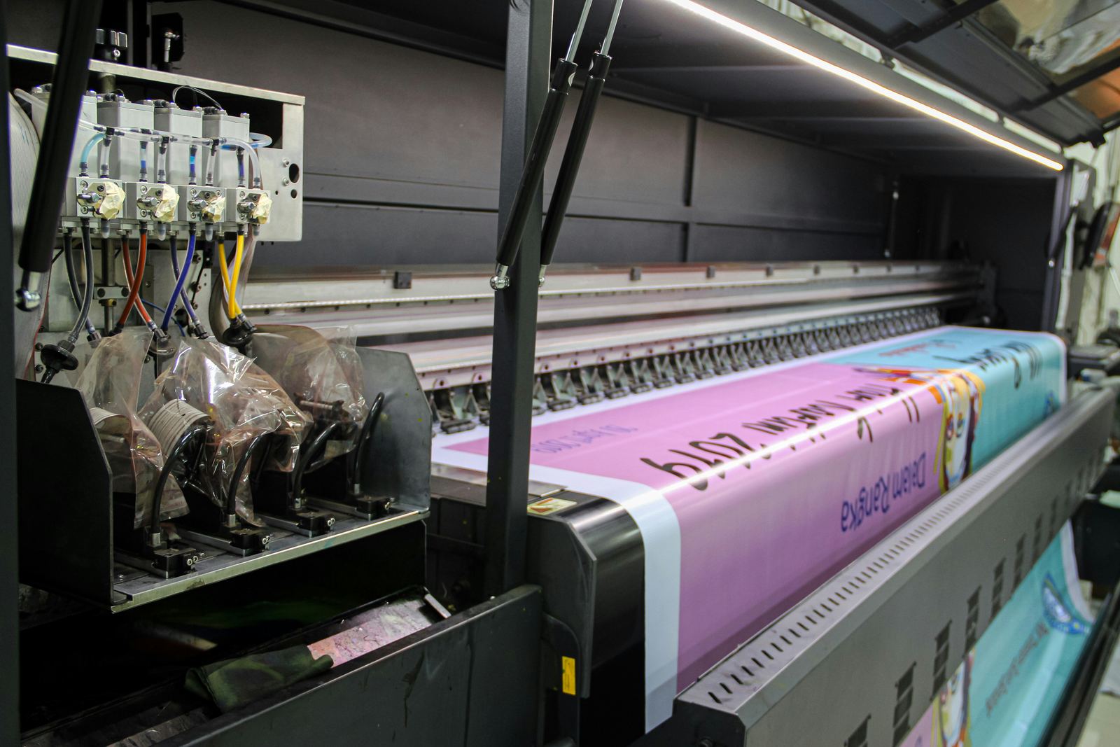 Wide-format printer running a full-colour banner at Accelerate Brand Studio in Johannesburg