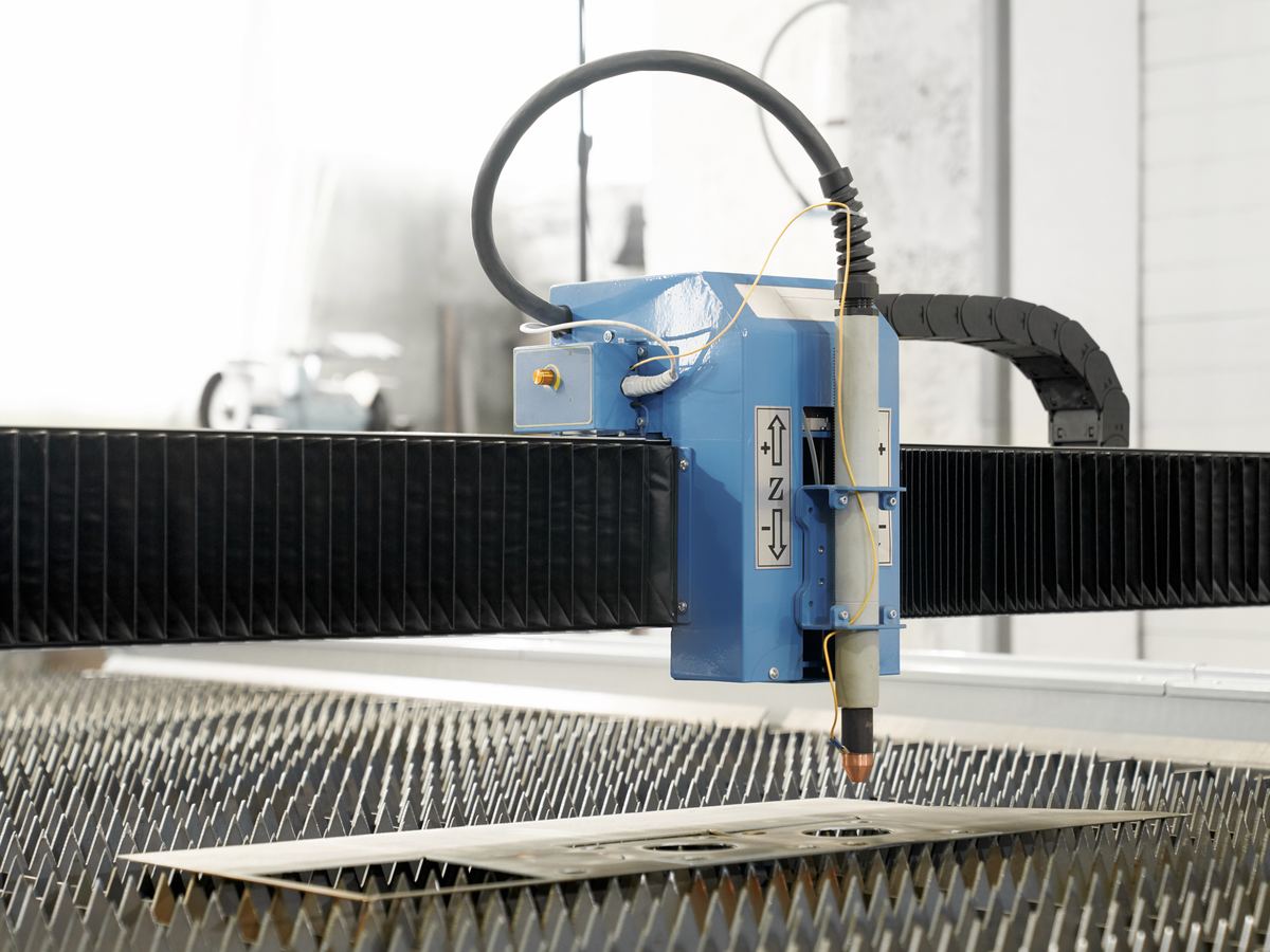 CNC plasma cutter cutting a precision profile in a manufacturing workshop